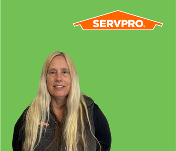 Woman in Front of SERVPRO green