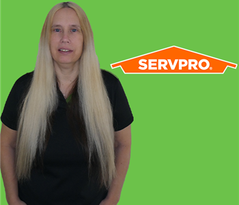 Woman in Front of SERVPRO green