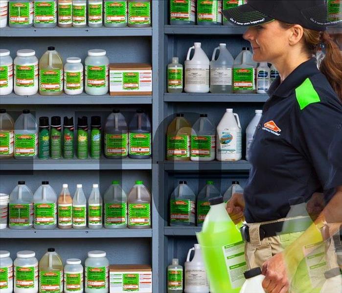 Woman with SERVPRO product, walking past shelves